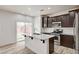 Modern eat in kitchen with stainless steel appliances, and backyard views at 7372 S Palo Real Ct, Las Vegas, NV 89179