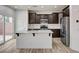 Bright eat in kitchen with stainless steel appliances, kitchen island, and backyard view at 7372 S Palo Real Ct, Las Vegas, NV 89179