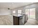 Kitchen island with stainless steel dishwasher, dark wood cabinets, and granite countertops at 7372 S Palo Real Ct, Las Vegas, NV 89179