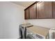 Laundry room with front-load washer and dryer and cabinetry at 7372 S Palo Real Ct, Las Vegas, NV 89179