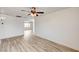 Open living area with ceiling fan and wood-look flooring at 7372 S Palo Real Ct, Las Vegas, NV 89179