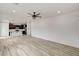 Open-concept living and kitchen area with modern lighting and vinyl flooring at 7372 S Palo Real Ct, Las Vegas, NV 89179