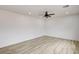 Spacious living room with modern ceiling fan, vinyl floors and neutral walls at 7372 S Palo Real Ct, Las Vegas, NV 89179