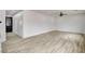 Bright, open living room with modern vinyl floors and a decorative entry door at 7372 S Palo Real Ct, Las Vegas, NV 89179