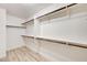 Spacious walk-in closet featuring multiple shelves and wood rod racks at 7372 S Palo Real Ct, Las Vegas, NV 89179