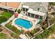 This home includes a private backyard with a pool, covered patio, lush landscaping, and outdoor seating area at 7920 Aspect Way, Las Vegas, NV 89149