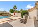 Outdoor space with pool, grill, and seating area, perfect for entertaining in this Las Vegas home at 7920 Aspect Way, Las Vegas, NV 89149