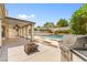 Spacious backyard featuring a covered patio, built-in barbeque, and a beautiful pool at 7920 Aspect Way, Las Vegas, NV 89149