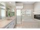 Bright bathroom with jacuzzi tub, glass shower, and tiled walls at 7920 Aspect Way, Las Vegas, NV 89149