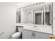 Bathroom features a bright mirror with vanity lighting, white cabinets, and sink at 7920 Aspect Way, Las Vegas, NV 89149