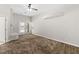 Spacious bedroom with plush carpeting, double doors to pool, and tiled fireplace at 7920 Aspect Way, Las Vegas, NV 89149