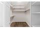Walk-in closet boasts shelves, wooden rods, and carpeted flooring at 7920 Aspect Way, Las Vegas, NV 89149