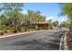 Gated community entrance provides security and exclusivity with desert-friendly landscaping and mature trees at 7920 Aspect Way, Las Vegas, NV 89149