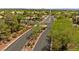 Aerial view of a gated community entrance with lush landscaping, palm trees, and scenic surroundings at 7920 Aspect Way, Las Vegas, NV 89149