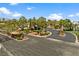 Gated community entrance with palm trees, landscaping, and winding roads at 7920 Aspect Way, Las Vegas, NV 89149