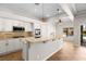 Bright kitchen boasts white cabinets, stainless appliances, and an eat-in breakfast bar at 7920 Aspect Way, Las Vegas, NV 89149