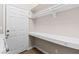 Convenient laundry room with shelving, hanging space, and a door to outside for easy access at 7920 Aspect Way, Las Vegas, NV 89149