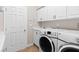Functional laundry room with sink, storage cabinets, counter, and included washer and dryer at 7920 Aspect Way, Las Vegas, NV 89149
