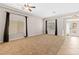 A spacious living room featuring plush carpeting and abundant natural light at 7920 Aspect Way, Las Vegas, NV 89149