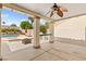 Covered patio with a ceiling fan, outdoor kitchen, and a view of the pool and landscaped backyard at 7920 Aspect Way, Las Vegas, NV 89149