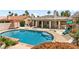 Inviting backyard pool with a covered patio area and lush landscaping, perfect for outdoor relaxation at 7920 Aspect Way, Las Vegas, NV 89149