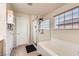 Bright main bathroom with a glass enclosed shower and soaking tub at 7928 Violet Dawn St, Las Vegas, NV 89149