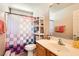 Cozy bathroom features a shelf over the toilet and a modern single sink vanity at 7928 Violet Dawn St, Las Vegas, NV 89149