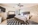 Spacious bedroom with a ceiling fan and black and white decorative rug at 7928 Violet Dawn St, Las Vegas, NV 89149