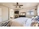 Bright main bedroom with ensuite bathroom, ceiling fan, and a decorative rug at 7928 Violet Dawn St, Las Vegas, NV 89149