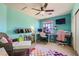 Vibrant bedroom featuring a ceiling fan, desk, and a fun colorful rug at 7928 Violet Dawn St, Las Vegas, NV 89149