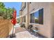 Charming outdoor patio with brick flooring, shaded seating, and string lights, perfect for relaxation and entertaining at 7928 Violet Dawn St, Las Vegas, NV 89149