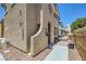 Charming two-story stucco home featuring an arched entryway and landscaped front with a cozy, inviting appeal at 7928 Violet Dawn St, Las Vegas, NV 89149