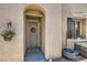 Inviting front entrance featuring a security door with patriotic wreath, stylish plants and modern outdoor accents at 7928 Violet Dawn St, Las Vegas, NV 89149