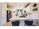 Open-concept kitchen with a breakfast bar, white cabinets, and stainless steel appliances, offering style and function at 7928 Violet Dawn St, Las Vegas, NV 89149