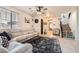Comfortable living room with neutral tones, plush seating, a stylish rug, and staircase access at 7928 Violet Dawn St, Las Vegas, NV 89149