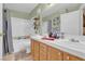 Well-lit bathroom with a double vanity sink, cabinets, and bathtub at 7950 W Flamingo Rd # 1003, Las Vegas, NV 89147