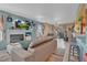 Open-concept living room with fireplace, tile flooring, and sliding door to patio at 7950 W Flamingo Rd # 1003, Las Vegas, NV 89147