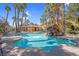 Community pool area with rock waterfall feature and covered lounge at 7950 W Flamingo Rd # 1003, Las Vegas, NV 89147