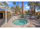 Inviting hot tub beside the community pool surrounded by palm trees at 7950 W Flamingo Rd # 1003, Las Vegas, NV 89147