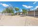 Large backyard with mature trees and a covered patio provides ample space for relaxation and recreation at 808 Reynolds Ave, North Las Vegas, NV 89030