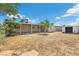 Spacious backyard featuring a covered patio, mature trees, and plenty of room for outdoor activities at 808 Reynolds Ave, North Las Vegas, NV 89030