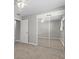 Bedroom featuring mirrored closet sliding doors and carpet at 808 Reynolds Ave, North Las Vegas, NV 89030