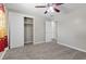Cozy bedroom with carpet, ceiling fan and closet with sliding doors at 808 Reynolds Ave, North Las Vegas, NV 89030