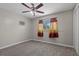 Carpeted bedroom with ceiling fan, AC unit and window with curtains at 808 Reynolds Ave, North Las Vegas, NV 89030