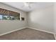 Empty carpeted bedroom with large window providing natural light at 808 Reynolds Ave, North Las Vegas, NV 89030