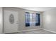 Clean entryway with a white door, a decorative window, and gray walls and floors at 808 Reynolds Ave, North Las Vegas, NV 89030
