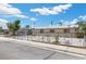 View of the front of a home with a metal gate, concrete driveway, and white gravel landscaping at 808 Reynolds Ave, North Las Vegas, NV 89030