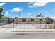 Home with a gated driveway, offering security and privacy, enhanced by white gravel landscaping elements at 808 Reynolds Ave, North Las Vegas, NV 89030
