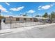 View of the front of a home with a metal gate, concrete driveway, white gravel, and partial view of neighboring property at 808 Reynolds Ave, North Las Vegas, NV 89030