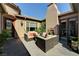Picturesque back patio featuring plush outdoor seating, an outdoor fireplace, and desert landscaping at 8564 Mayport Dr, Las Vegas, NV 89131